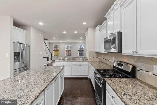 a kitchen with a stove sink and cabinets