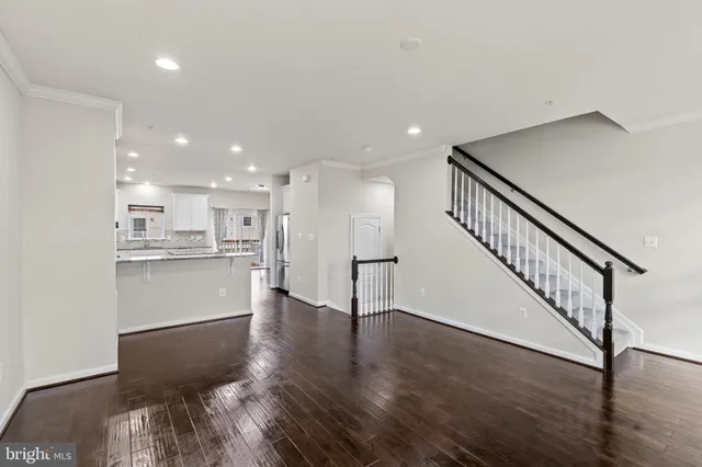 a view of kitchen with wooden floor and electronic appliances