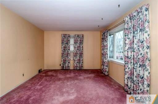 4 North Pennington Road New Brunswick, NJ 08901 - Photo 5 of 14 a view of an empty room with a window and a kitchen