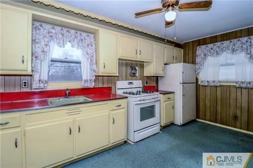 4 North Pennington Road New Brunswick, NJ 08901 - Photo 7 of 14 a kitchen with a stove and a refrigerator