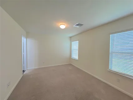 a view of an empty room with a window
