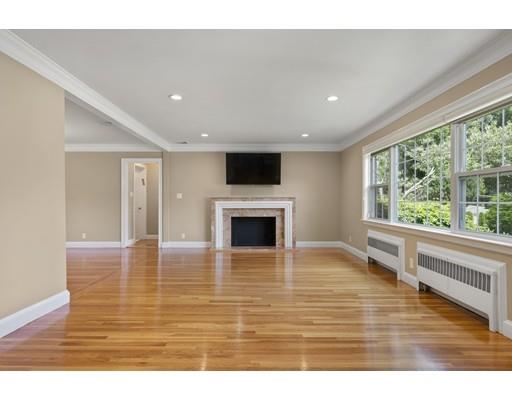 66 Broken Tree Road Newton, MA 02459 - Photo 4 of 26 a view of empty room with wooden floor and fireplace