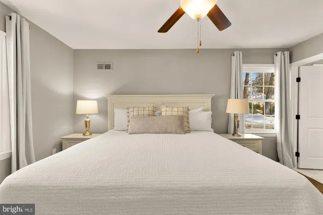 a bedroom with a large bed and a chandelier