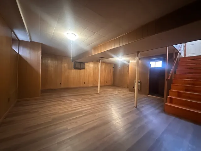 a view of a room with wooden floor