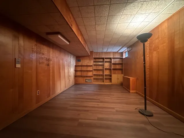 a view of an empty room with a wooden wall