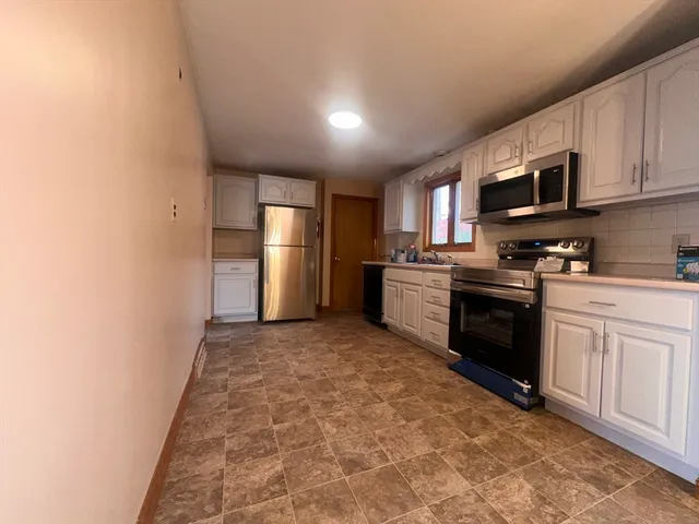 a kitchen with stainless steel appliances granite countertop a refrigerator sink and cabinets