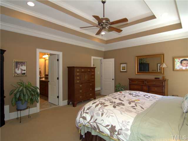 96 Avalant Pittsboro, NC 27312 - Photo 12 of 25 a bedroom with a bed and a chandelier