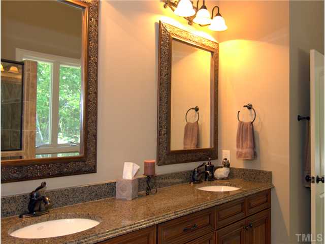 96 Avalant Pittsboro, NC 27312 - Photo 14 of 25 a bathroom with a double vanity sink and a mirror