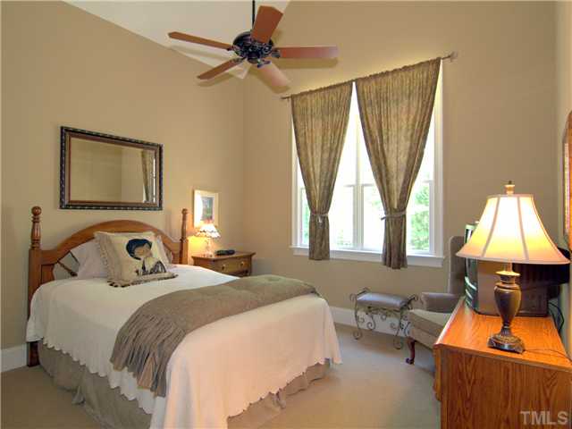96 Avalant Pittsboro, NC 27312 - Photo 16 of 25 a bedroom with a bed and a chandelier