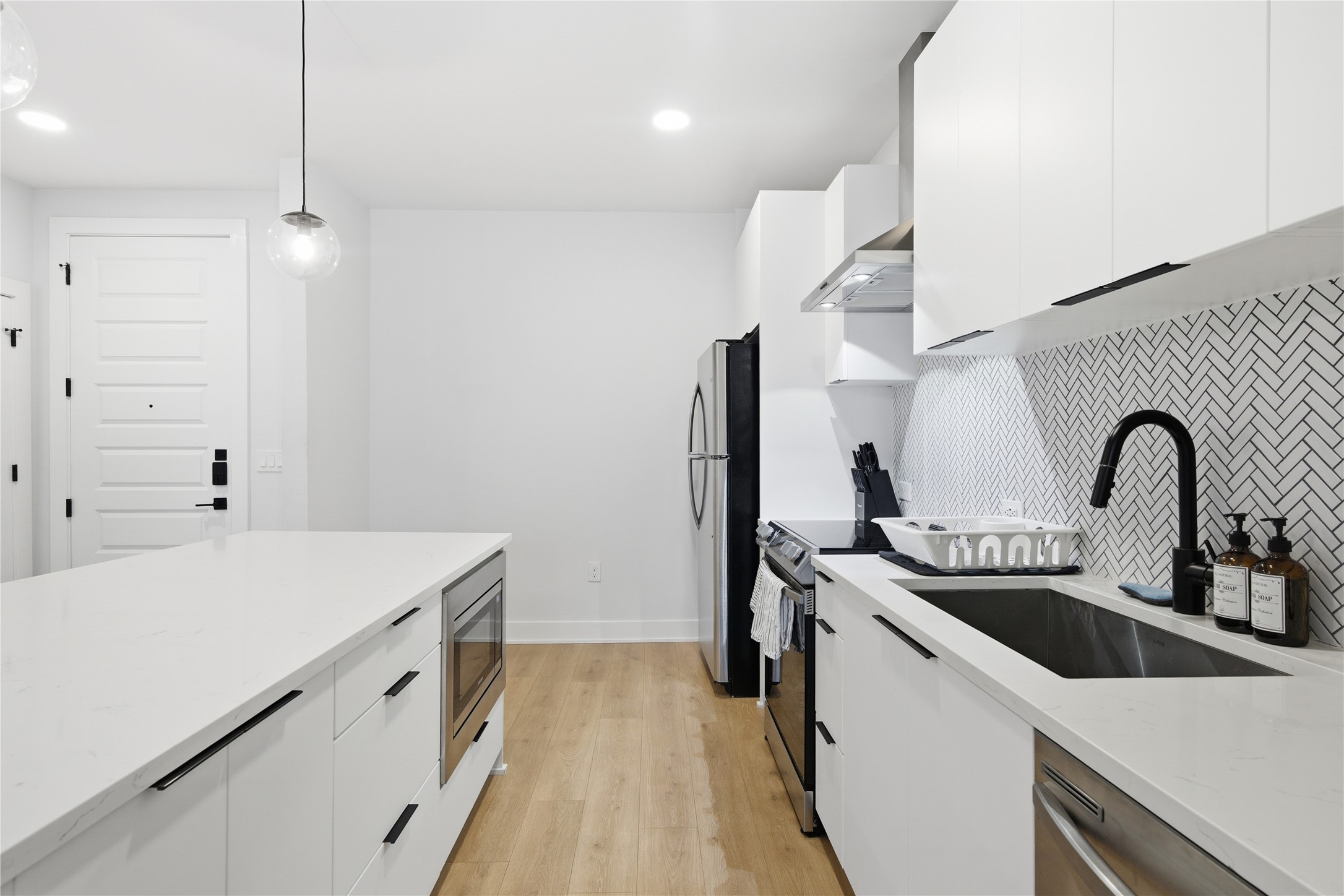 2500 Longview Street, Unit 219 Austin, TX 78705 - Photo 7 of 40 Kitchen with white cabinetry, modern cabinets, decorative light fixtures, and recessed lighting