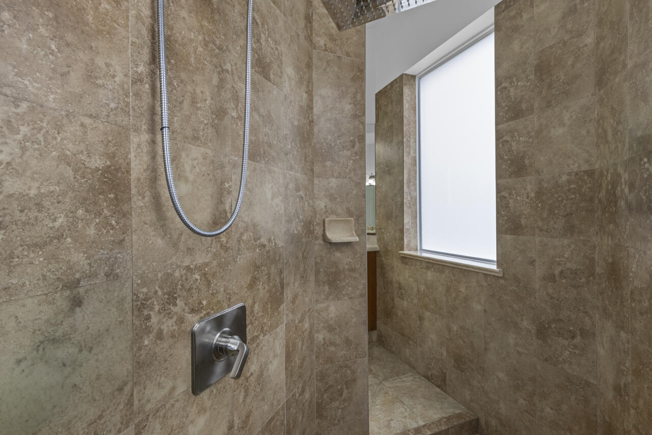 8300 Southwest Cattleya Drive Stuart, FL 34997 - Photo 14 of 77 a bathroom with a shower