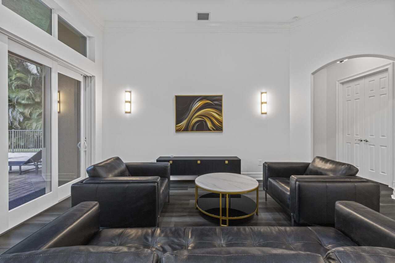 8300 Southwest Cattleya Drive Stuart, FL 34997 - Photo 18 of 77 a living room with furniture a rug and a window