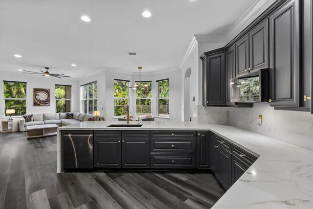 a kitchen with kitchen island a sink appliances and cabinets