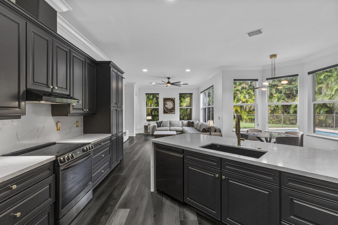 8300 Southwest Cattleya Drive Stuart, FL 34997 - Photo 25 of 77 a kitchen with lots of counter top space a sink and appliances
