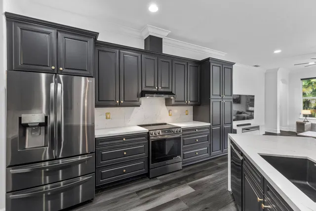 a kitchen with a table chairs stove and cabinets