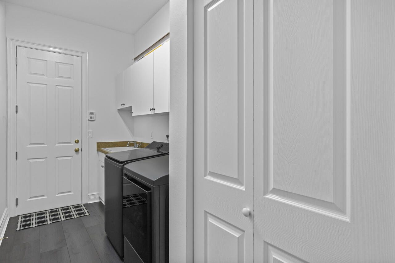 8300 Southwest Cattleya Drive Stuart, FL 34997 - Photo 28 of 77 a utility room with a sink washer and dryer