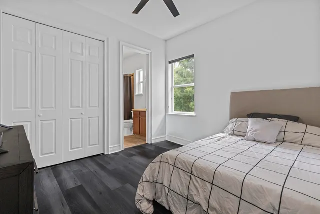 a bedroom with a bed a lamp and a window