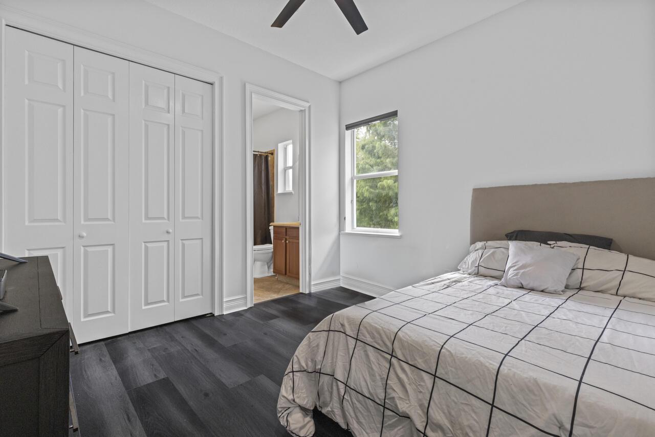 8300 Southwest Cattleya Drive Stuart, FL 34997 - Photo 29 of 77 a bedroom with a bed and a window