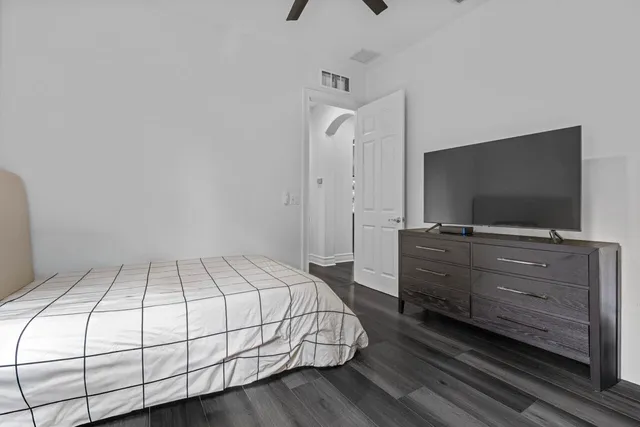 a bathroom with a toilet a sink a mirror and vanity