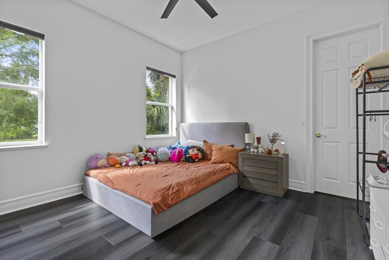 8300 Southwest Cattleya Drive Stuart, FL 34997 - Photo 32 of 77 a bedroom with bed and window