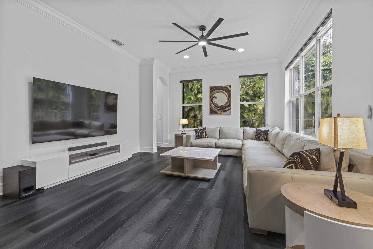 8300 Southwest Cattleya Drive Stuart, FL 34997 - Photo 40 of 77 a living room with furniture and a flat screen tv