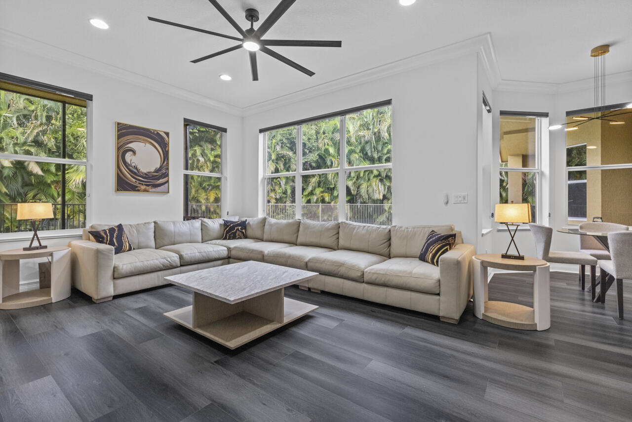 8300 Southwest Cattleya Drive Stuart, FL 34997 - Photo 42 of 77 a living room with furniture and a large window