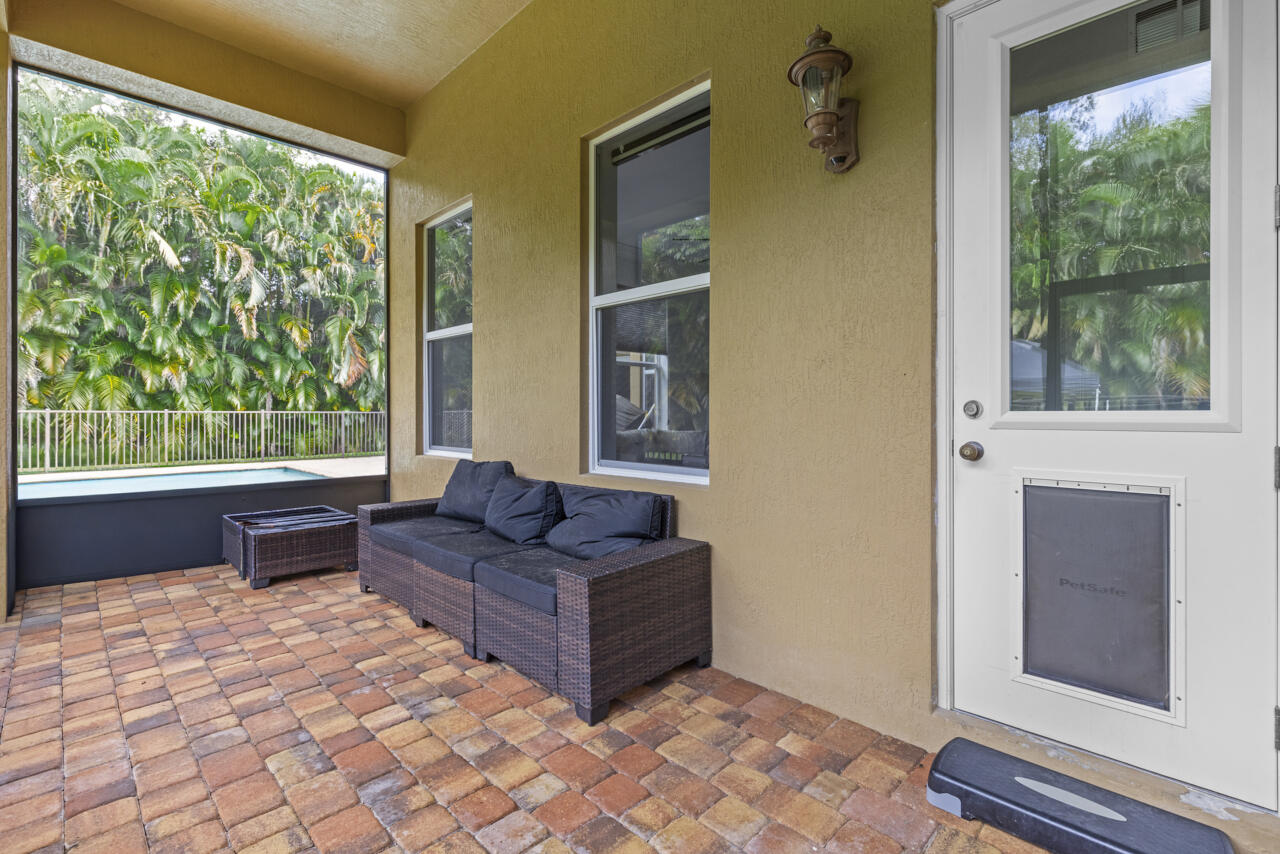 8300 Southwest Cattleya Drive Stuart, FL 34997 - Photo 48 of 77 a living room with furniture and a window