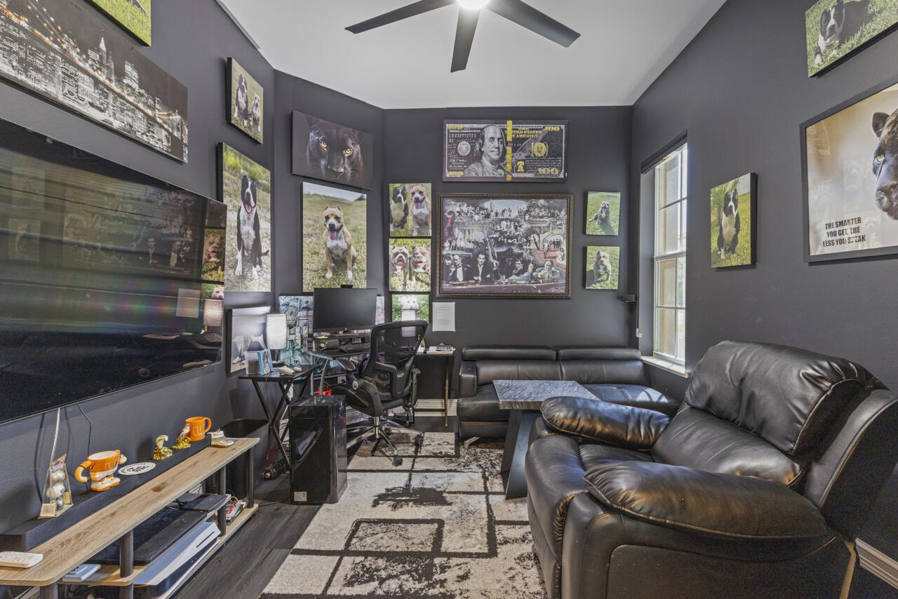 8300 Southwest Cattleya Drive Stuart, FL 34997 - Photo 49 of 77 a living room with furniture chess board and a fireplace