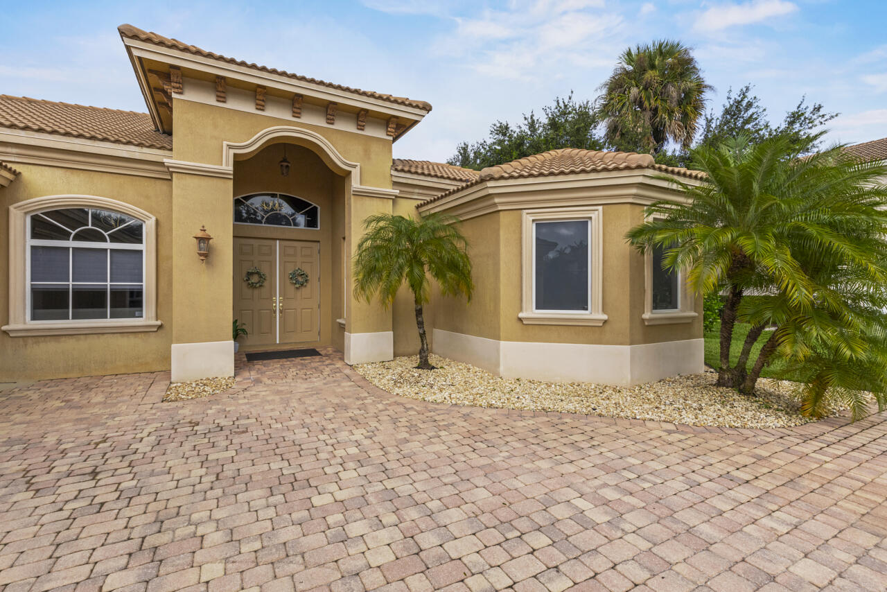8300 Southwest Cattleya Drive Stuart, FL 34997 - Photo 5 of 77 a front view of a house with a yard