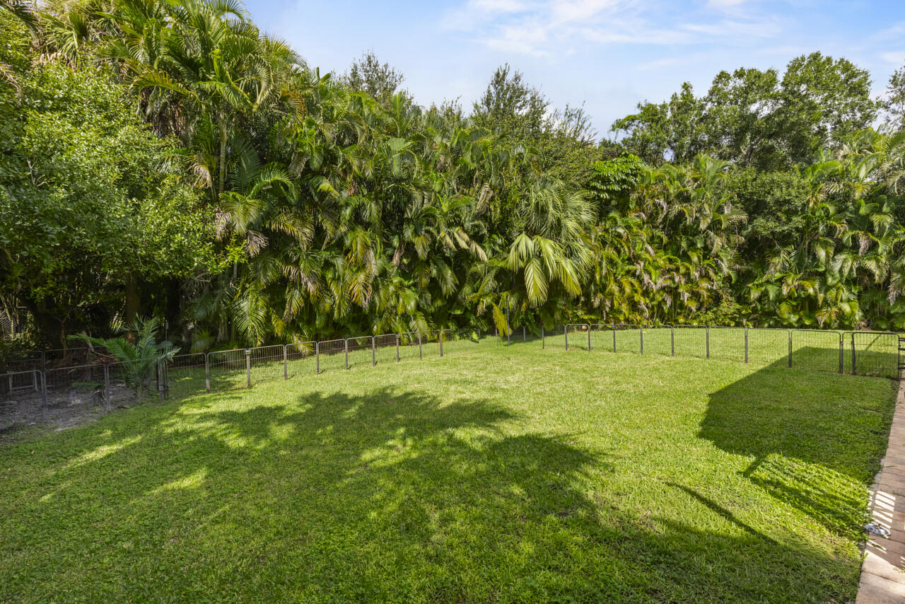 8300 Southwest Cattleya Drive Stuart, FL 34997 - Photo 55 of 77 a backyard of a house with lots of green space