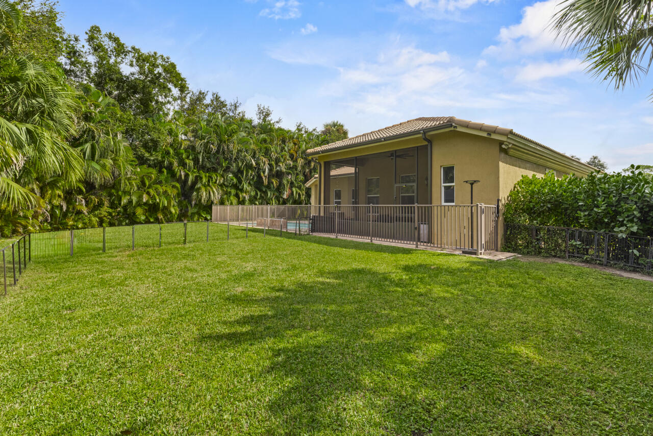 8300 Southwest Cattleya Drive Stuart, FL 34997 - Photo 56 of 77 a front view of a house with a garden