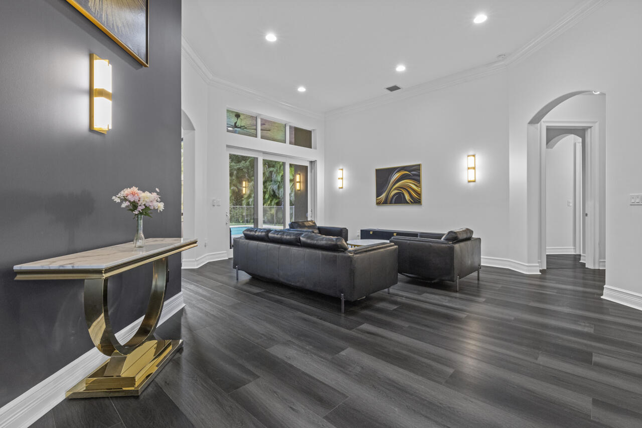 8300 Southwest Cattleya Drive Stuart, FL 34997 - Photo 6 of 77 a living room with furniture and a large window