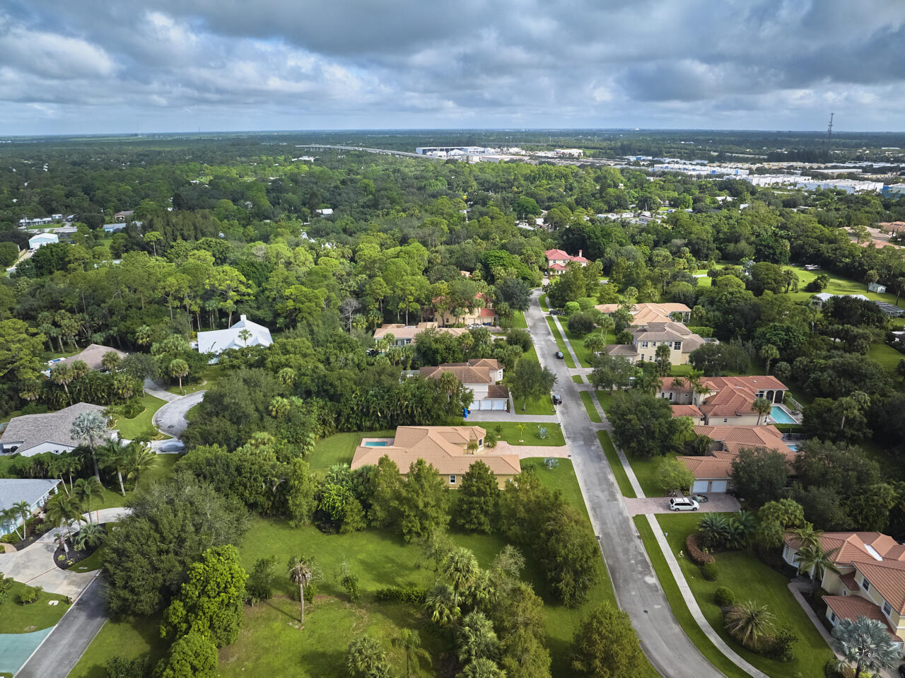 8300 Southwest Cattleya Drive Stuart, FL 34997 - Photo 70 of 77 an aerial view of residential houses with outdoor space and trees