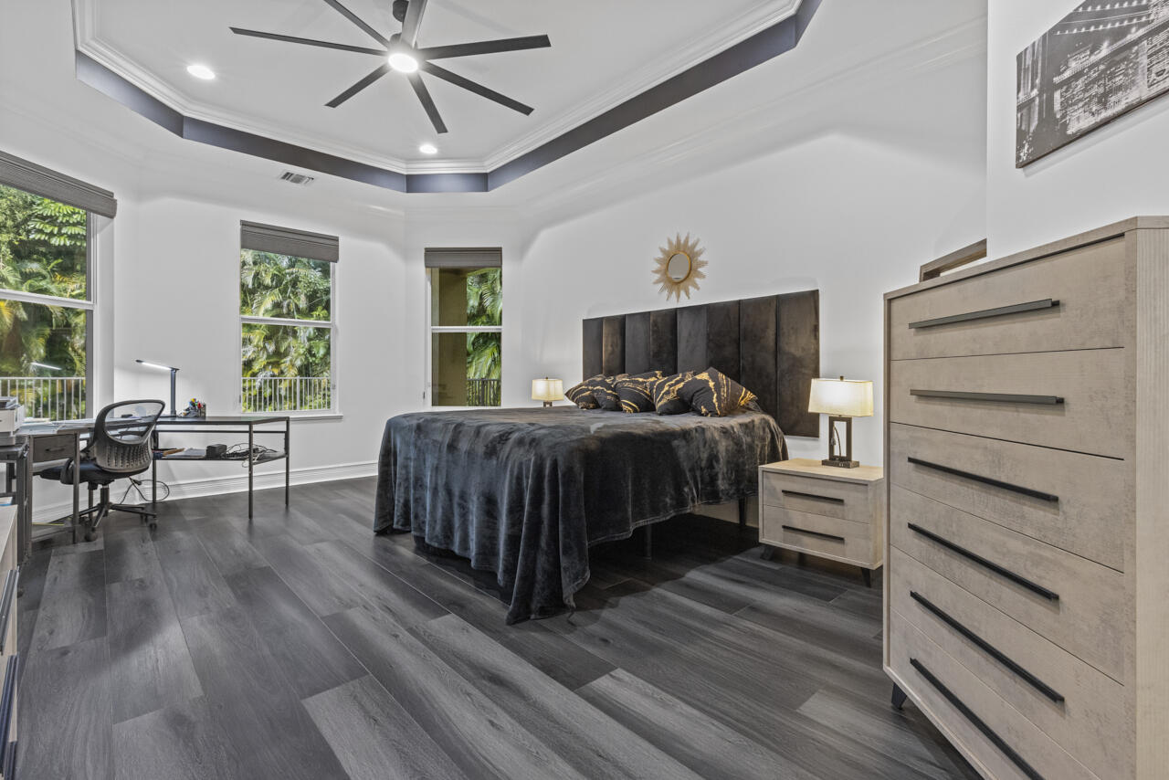 8300 Southwest Cattleya Drive Stuart, FL 34997 - Photo 7 of 77 a bedroom with a bed and a table