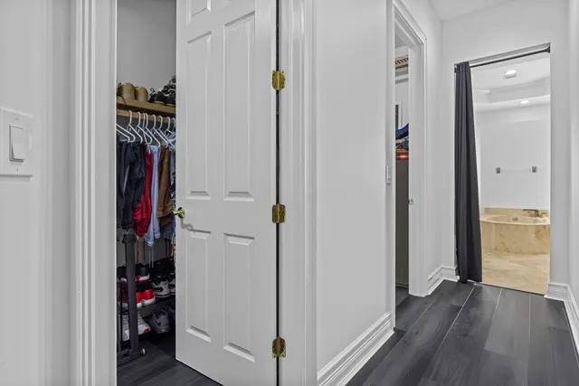 a spacious bathroom with a tub sink and mirror