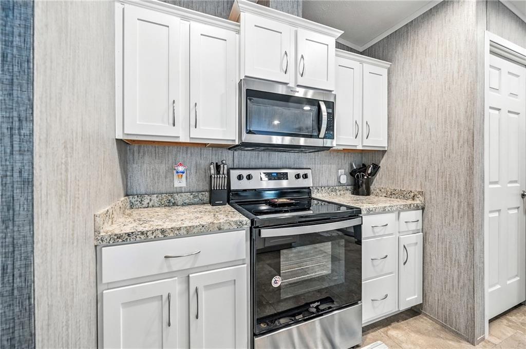 73 South Summit Road, Unit 503 Greenville, PA 16125 - Photo 9 of 36 a kitchen with white cabinets and stainless steel appliances