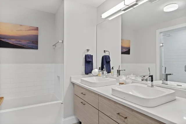 a bathroom with a double vanity sink mirror and double