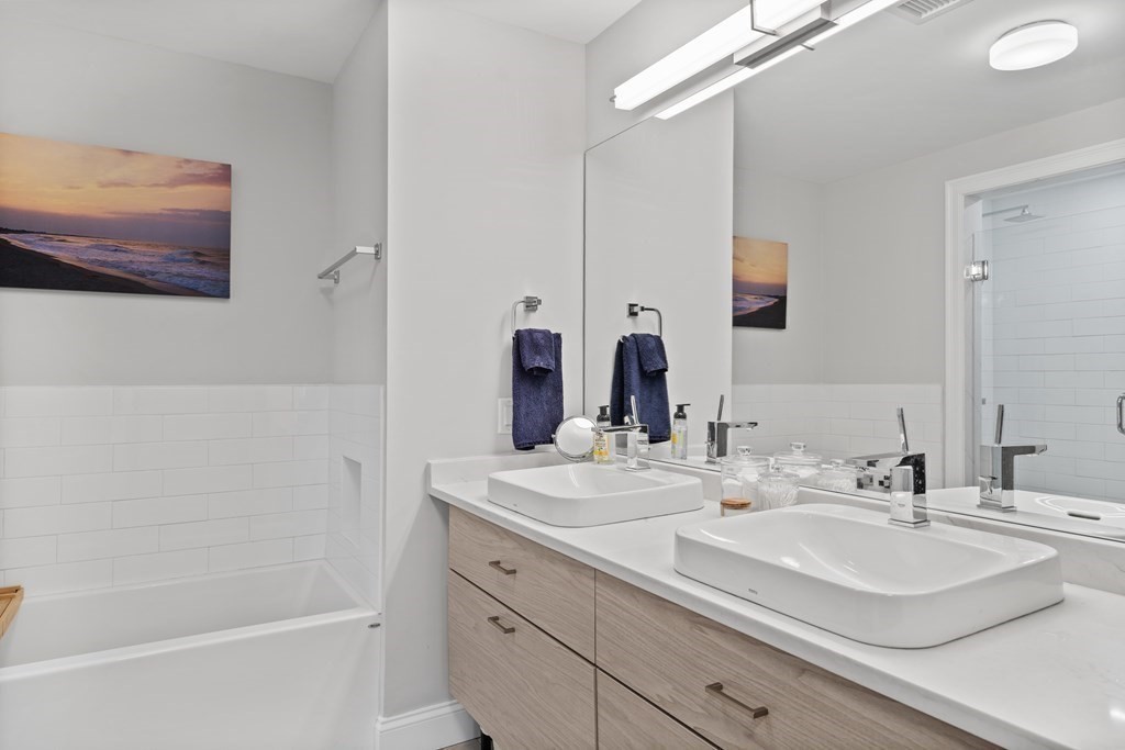 771 Harrison Avenue, Unit 207 Boston, MA 02118 - Photo 12 of 28 a bathroom with a double vanity sink mirror and double