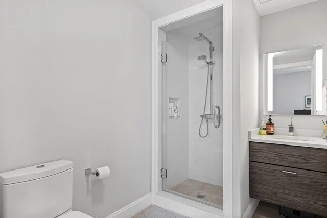 a bathroom with a shower a toilet and a sink