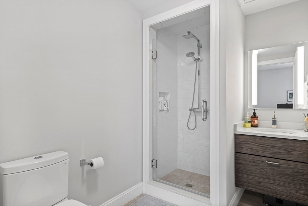 771 Harrison Avenue, Unit 207 Boston, MA 02118 - Photo 16 of 28 a bathroom with a shower a toilet and a sink