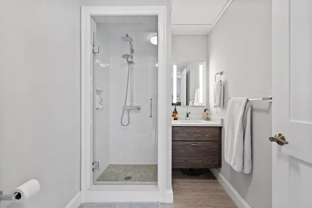 a bathroom with a shower and a sink