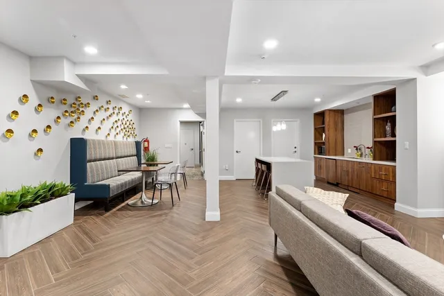a living room with furniture and kitchen view