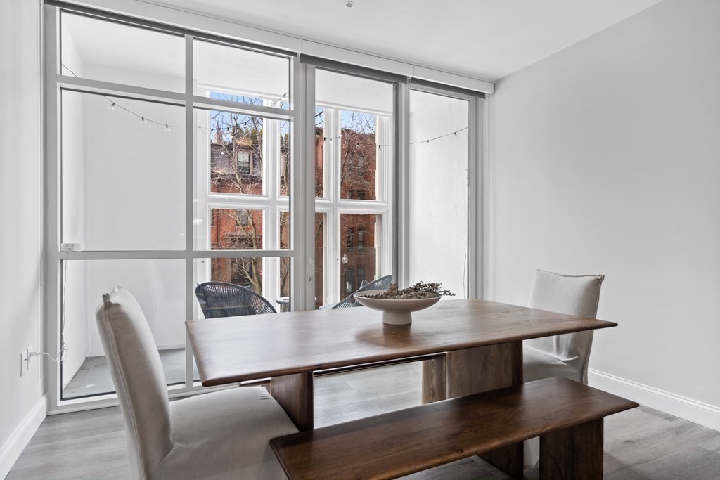 771 Harrison Avenue, Unit 207 Boston, MA 02118 - Photo 5 of 28 a view of a dining room with furniture and window