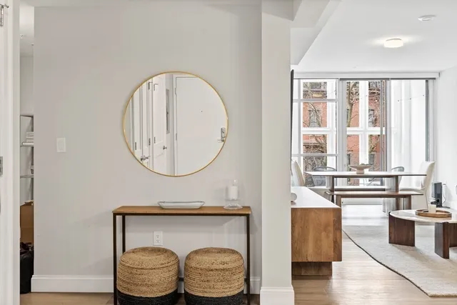 a bathroom with a granite countertop bathtub a sink and a large mirror