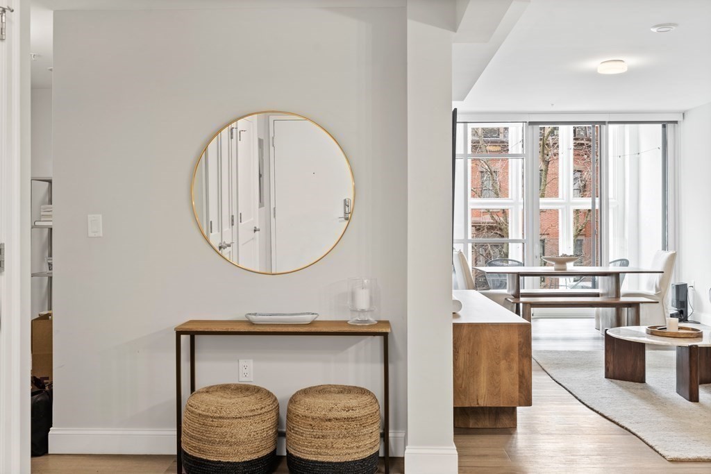 771 Harrison Avenue, Unit 207 Boston, MA 02118 - Photo 7 of 28 a bathroom with a granite countertop bathtub a sink and a large mirror