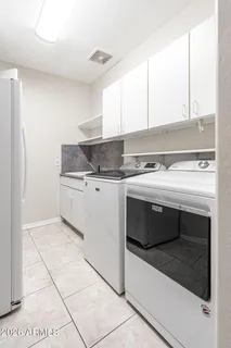 a kitchen with a stove top oven and cabinets