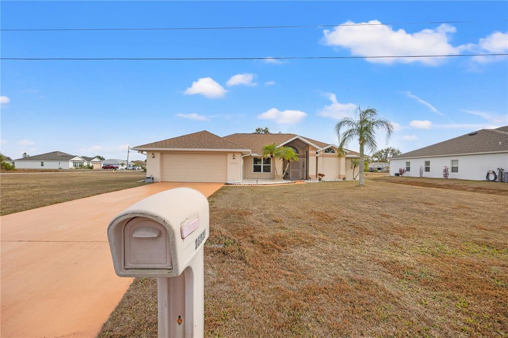 26223 Barcelos Court Punta Gorda, FL 33983 - Photo 30 of 34 a front view of a house with garden