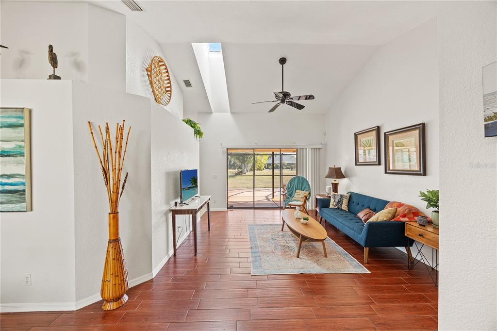 26223 Barcelos Court Punta Gorda, FL 33983 - Photo 4 of 34 a living room with furniture and a wooden floor