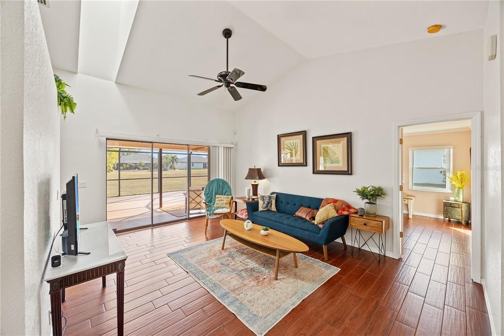 26223 Barcelos Court Punta Gorda, FL 33983 - Photo 7 of 34 a living room with furniture large window and wooden floor
