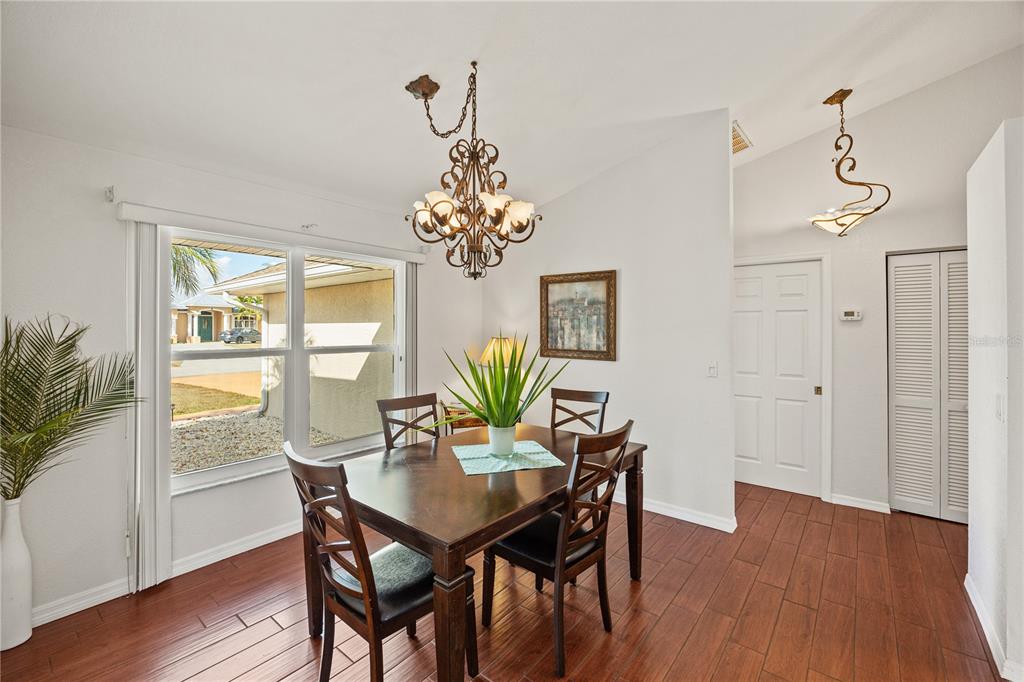 26223 Barcelos Court Punta Gorda, FL 33983 - Photo 9 of 34 a view of a dining room with furniture wooden floor and chandelier